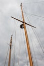 Two masts from a large sailboat against a stormy sky with clouds Royalty Free Stock Photo