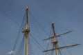 Two masts, rigging and shrouds on an old tall ship against a blue sky Royalty Free Stock Photo