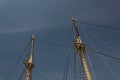 Two masts and rigging of a vintage tall ship before gloomy dark sky, marine themed backdrop Royalty Free Stock Photo