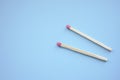 Two matches on a blue paper table Royalty Free Stock Photo