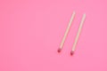 Two matches on a pink paper table Royalty Free Stock Photo