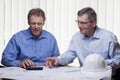 Two mature architects or engineers calcutating a project Royalty Free Stock Photo