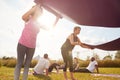 Two Mature Female Friends Laying Out Exercise Mats On Grass At Outdoor Yoga Retreat Royalty Free Stock Photo