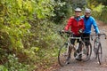 Two Mature Male Cyclists Riding Bikes Along Path Royalty Free Stock Photo