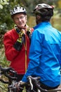 Two Mature Male Cyclists Riding Bikes Along Path Royalty Free Stock Photo