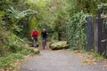 Two Mature Male Cyclists Riding Bikes Along Path Royalty Free Stock Photo