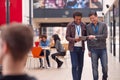 Two Mature Male Students Or Teachers With Digital Tablet Walk Through Hall Of College Building Royalty Free Stock Photo