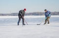 Two mature man fighting for the pack while playing amateur hockey on a frozen river Dnepr in Ukraine