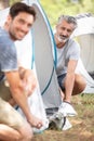 two mature men erecting tent Royalty Free Stock Photo