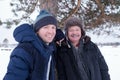 Two mature men father and son dressed in warm clothes sniling and looking at camera Royalty Free Stock Photo