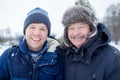 Two mature men father and son dressed in warm clothes sniling and looking at camera Royalty Free Stock Photo
