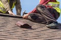 Workman install element of tile roof on new home under construction