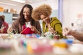 Two Mature Women Attending Art Class In Community Centre Together