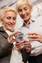 Two mature women choosing prescription lenses to match with new reading glasses Royalty Free Stock Photo