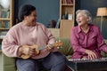 Two Mature Women Laughing Playing Music