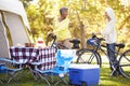 Two Mature Women Riding Bikes On Camping Holiday Royalty Free Stock Photo