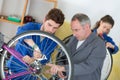 Two mechanics in bike repair station Royalty Free Stock Photo