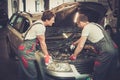 Two mechanics fixing car Royalty Free Stock Photo