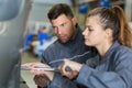 two mechanics operating wheel equilibrium control machinery Royalty Free Stock Photo