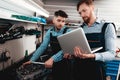 Two Mechanics Work Together On Service Station. Royalty Free Stock Photo