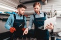 Two Mechanics Work Together On Service Station. Royalty Free Stock Photo