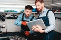 Two Mechanics Work Together On Service Station. Royalty Free Stock Photo