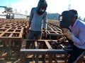 two mechanics working during railway iron bridge construction on site in India January 2020 Royalty Free Stock Photo