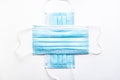 Two medical blue disposable face shields one on top of the other crosswise on a white background. A surgical dressing Royalty Free Stock Photo