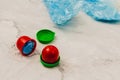 Two medical blue shoe covers in individual capsules with green\red colored caps. Disposable shoe covers. Protection concept Royalty Free Stock Photo