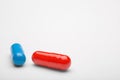 Two medical pills blue and red with a shadows Royalty Free Stock Photo