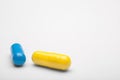 Two medical pills blue and yellow with a shadows Royalty Free Stock Photo