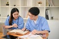 Two medical students are studying and researching medical information at the library together Royalty Free Stock Photo
