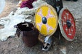 Two medieval round shield, late ancient roman burgh castle type helmet and plate leather armor, animal fur in background