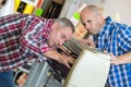 Two men adjusting air conditioning system Royalty Free Stock Photo