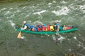 Two men in adventure canoe on rushing river rapids