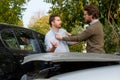 Two men arguing after a car accident on the road Royalty Free Stock Photo