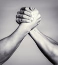 Two men arm wrestling. Arms wrestling. Closep up. Friendly handshake, friends greeting, teamwork, friendship. Handshake Royalty Free Stock Photo