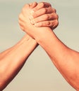 Two men arm wrestling. Arms wrestling. Closep up. Friendly handshake, friends greeting, teamwork, friendship. Handshake Royalty Free Stock Photo