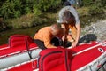 Two men assemble an inflatable catamaran.