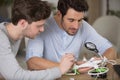 two men assembling components drone