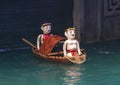 Two men in a boat water puppets in the Thang Long Water Puppet Theatre, Hanoi, Vietnam