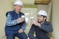 Two men builders coffee break