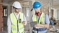 Two men builders using touchpad at construction site Royalty Free Stock Photo