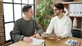 Two men business partners reading document at office