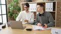 Two men business partners using laptop and smartphone working at office Royalty Free Stock Photo