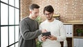 Two men business partners using touchpad working at office Royalty Free Stock Photo