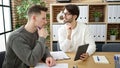 Two men business partners using touchpad working at office Royalty Free Stock Photo