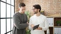 Two men business partners using touchpad working at office Royalty Free Stock Photo