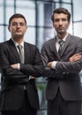 Two men business workers standing with arms crossed gesture at office Royalty Free Stock Photo