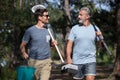 two men carrying fishing equipment Royalty Free Stock Photo